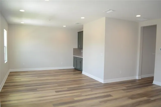 a view of wooden floor and windows in a room