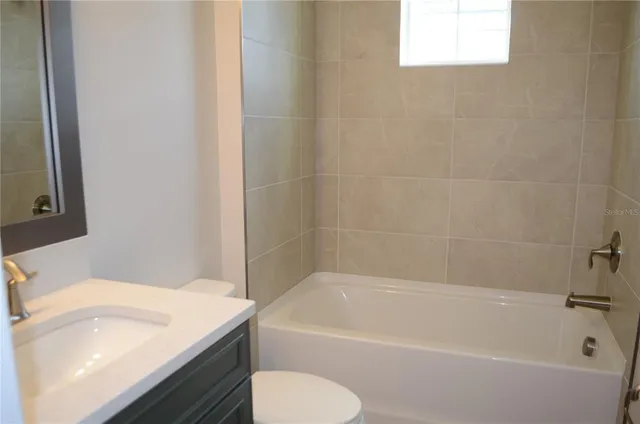 a view of a bathroom with a tub sink