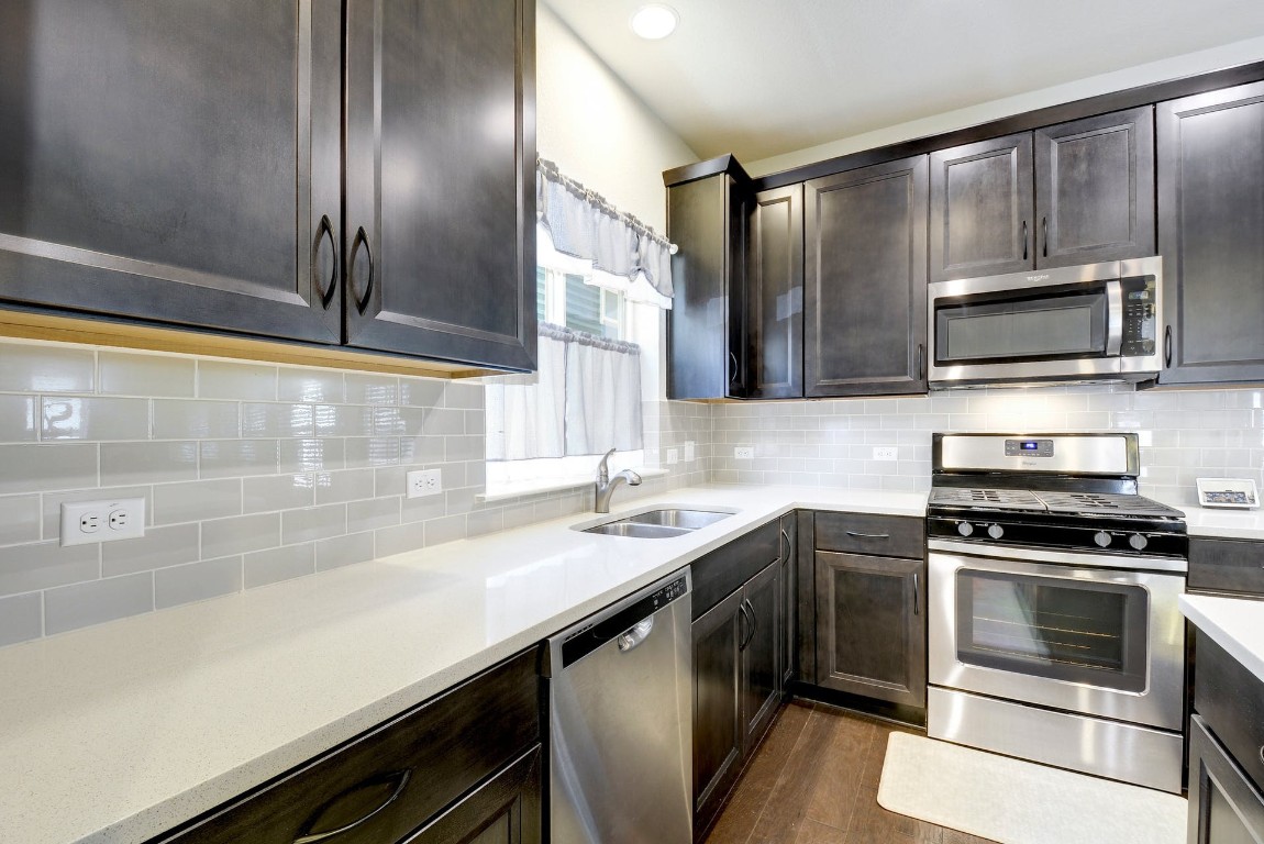 2012 Cleese Drive, Unit 182C Austin, TX 78741 - Photo 11 of 24 a kitchen with a sink stove and microwave