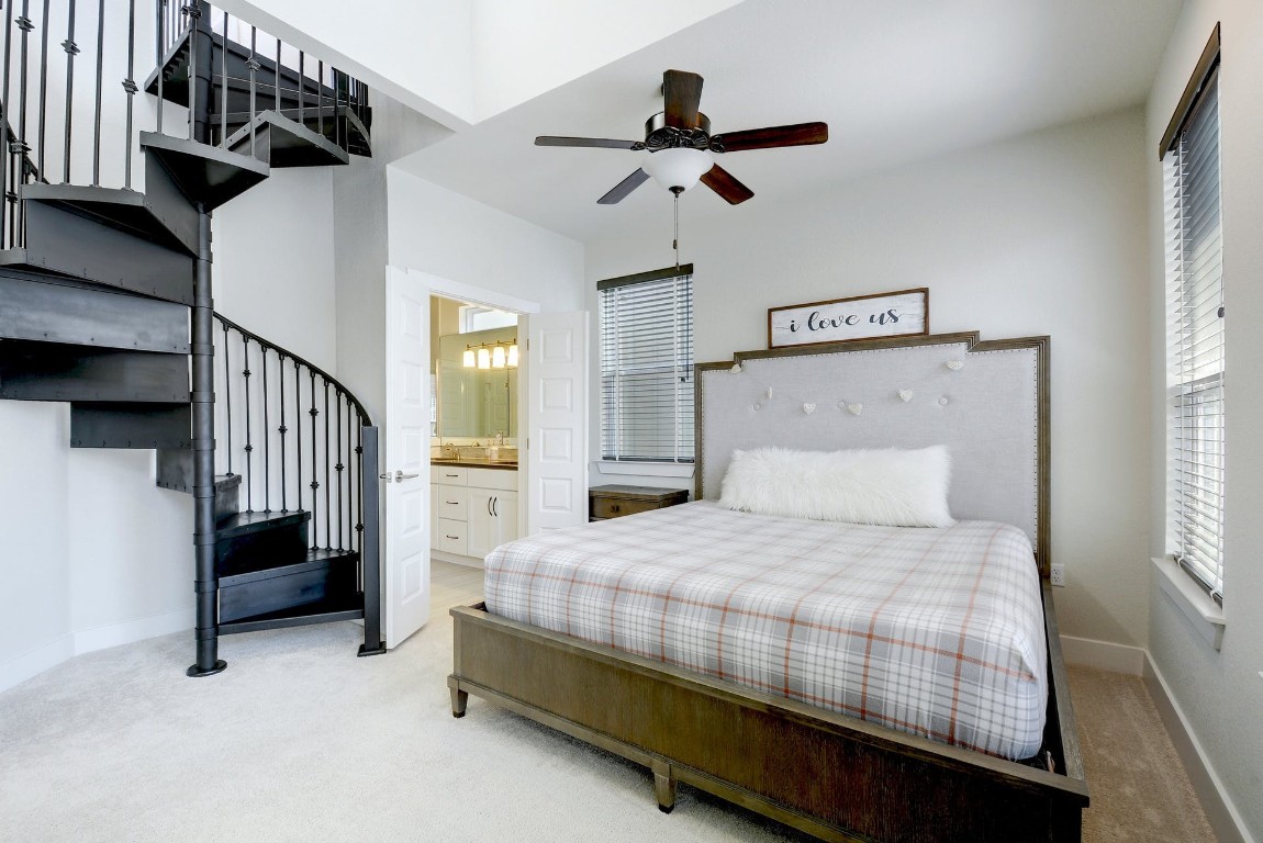 2012 Cleese Drive, Unit 182C Austin, TX 78741 - Photo 14 of 24 a bedroom with a bed and a chandelier