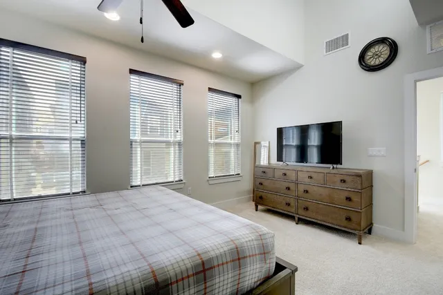 a bedroom with furniture and flat screen tv