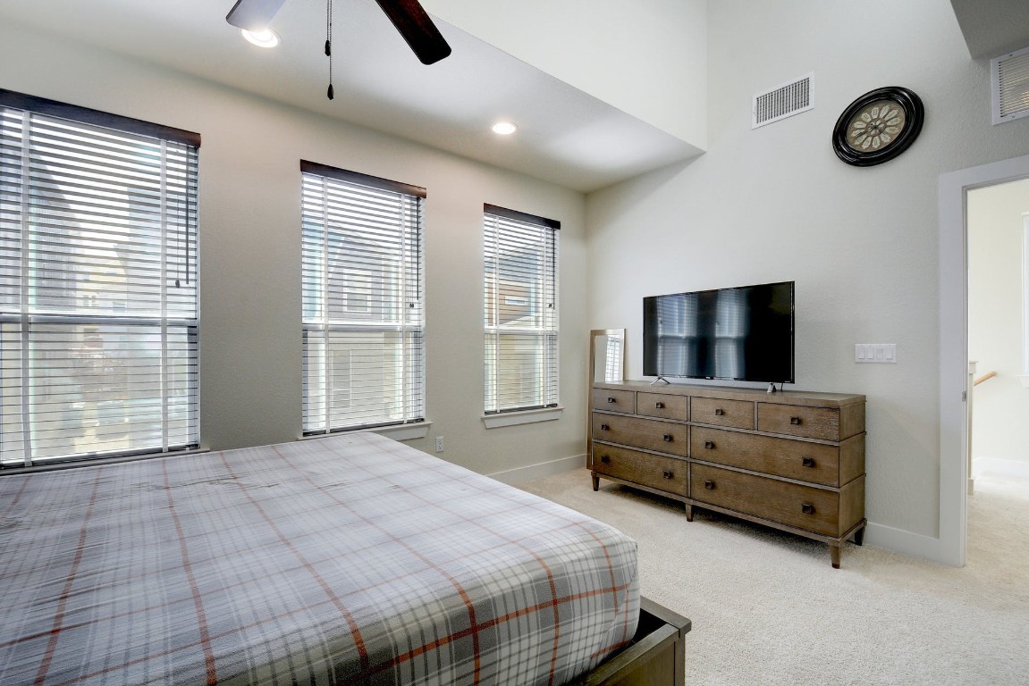 2012 Cleese Drive, Unit 182C Austin, TX 78741 - Photo 15 of 24 a bedroom with furniture and flat screen tv