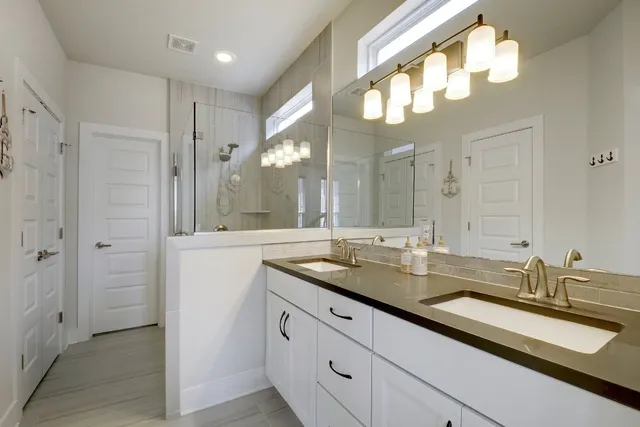 a bathroom with a sink double vanity and a mirror