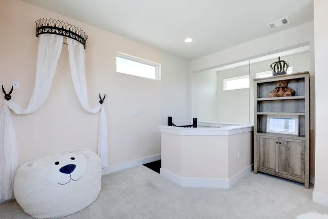 a view of kitchen with cabinets and window