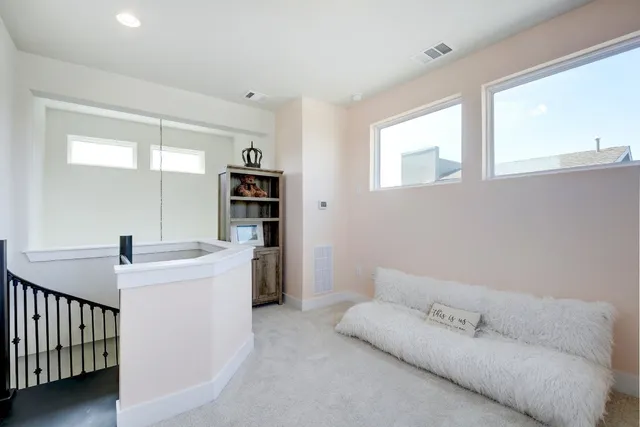 a living room with furniture and a book shelf