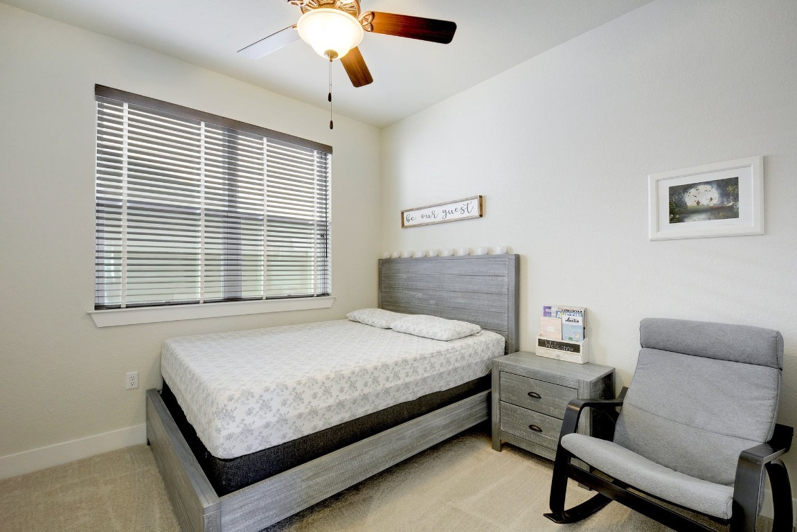 2012 Cleese Drive, Unit 182C Austin, TX 78741 - Photo 19 of 24 a bedroom with a bed and a couch