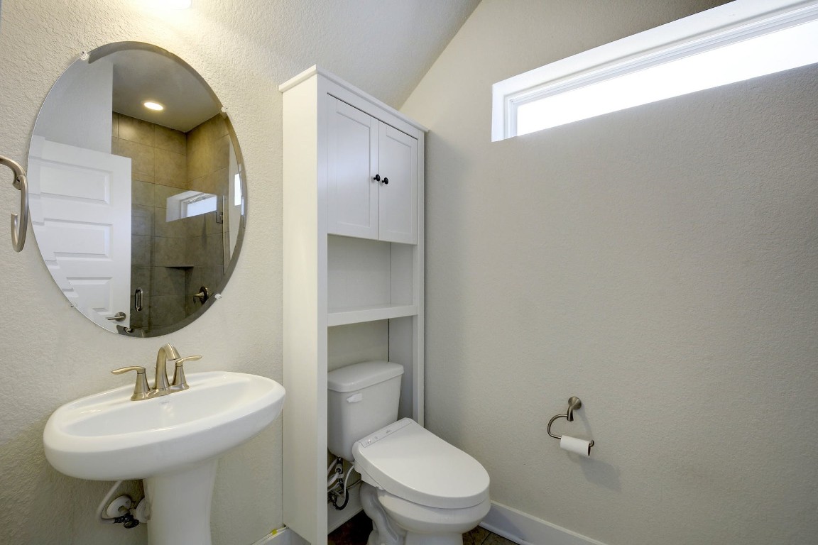 2012 Cleese Drive, Unit 182C Austin, TX 78741 - Photo 22 of 24 a bathroom with a toilet a sink and mirror