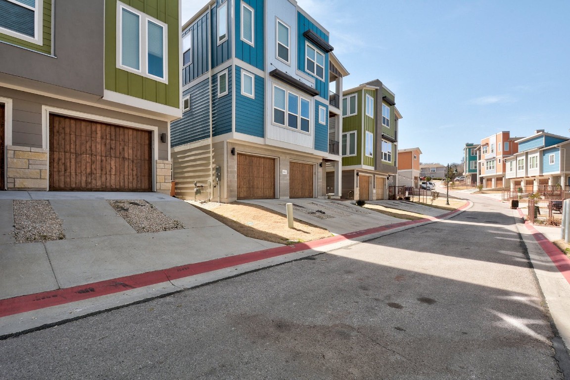 2012 Cleese Drive, Unit 182C Austin, TX 78741 - Photo 24 of 24 a tall building with trees in front of it