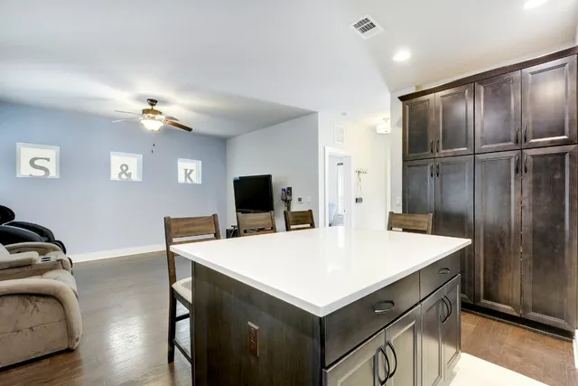 a room with a table and a refrigerator