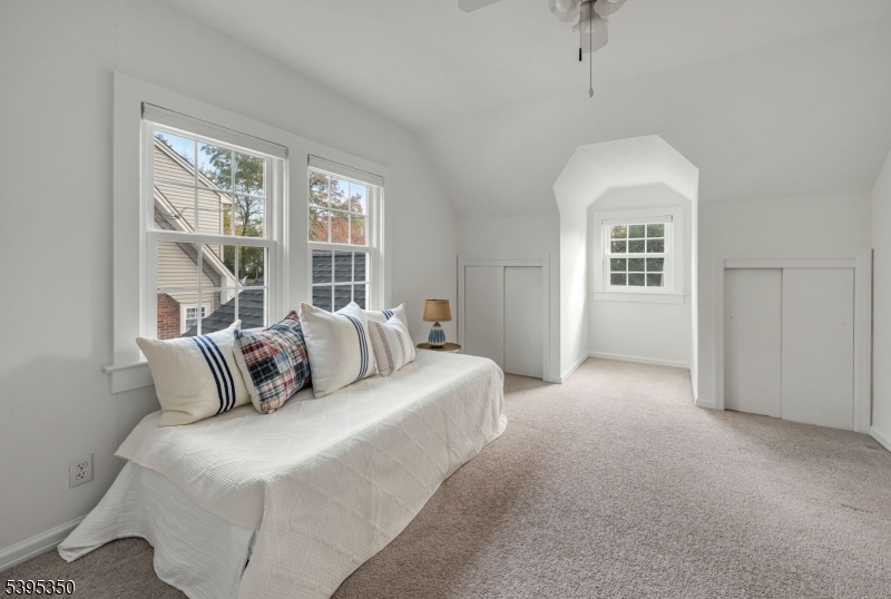 431 Goffle Road Wyckoff, NJ 07481 - Photo 11 of 20 a bedroom with a large bed and a chandelier