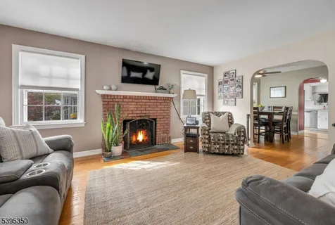 a living room with furniture flat screen tv and a fireplace