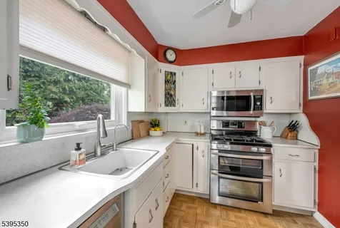 a kitchen that has a sink and a stove top oven