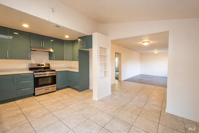 a kitchen with stainless steel appliances kitchen island granite countertop a refrigerator and a sink