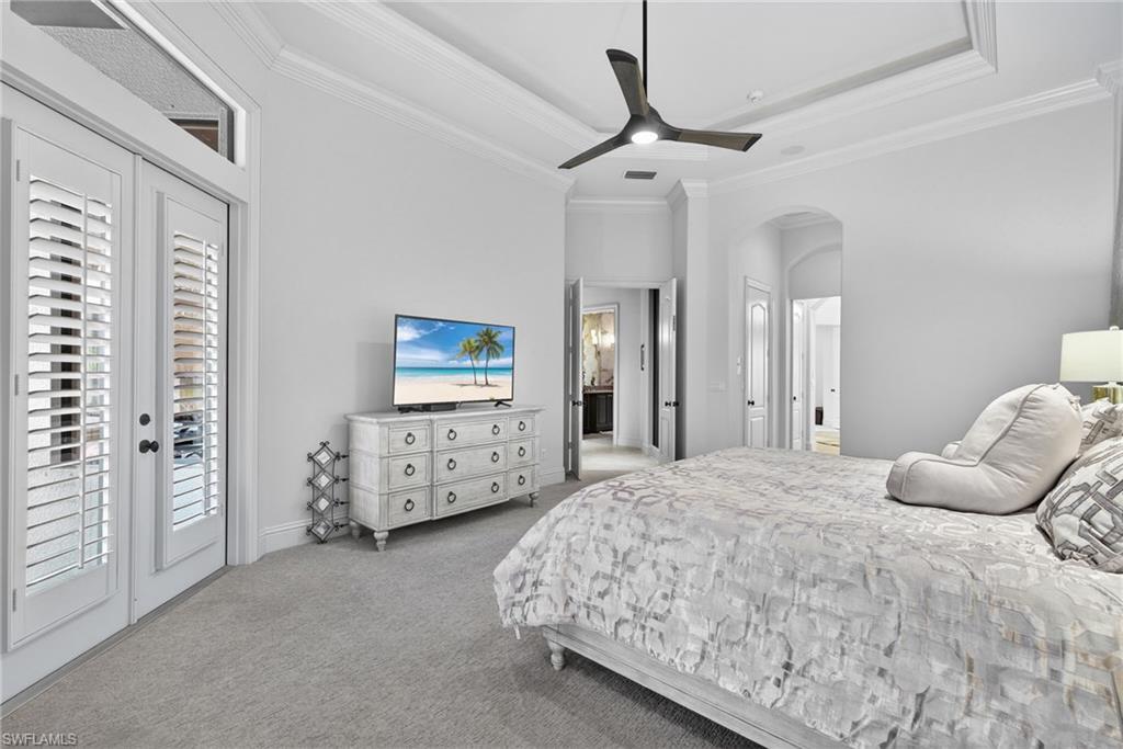 16488 Felicita Court Naples, FL 34110 - Photo 18 of 50 a bedroom with a bed and ceiling fan