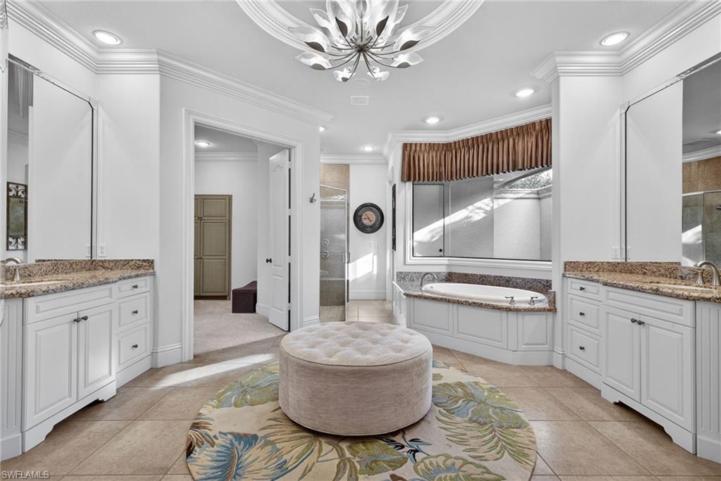 16488 Felicita Court Naples, FL 34110 - Photo 20 of 50 a spacious bathroom with a granite countertop sink mirror and toilet