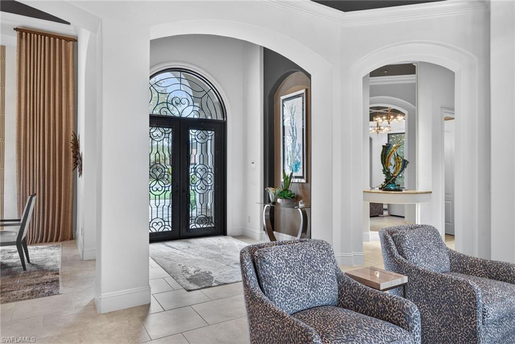 16488 Felicita Court Naples, FL 34110 - Photo 2 of 50 a living room with furniture and a large window