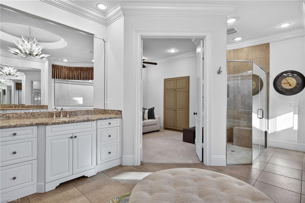 16488 Felicita Court Naples, FL 34110 - Photo 21 of 50 a bathroom with a granite countertop sink a mirror and a shower