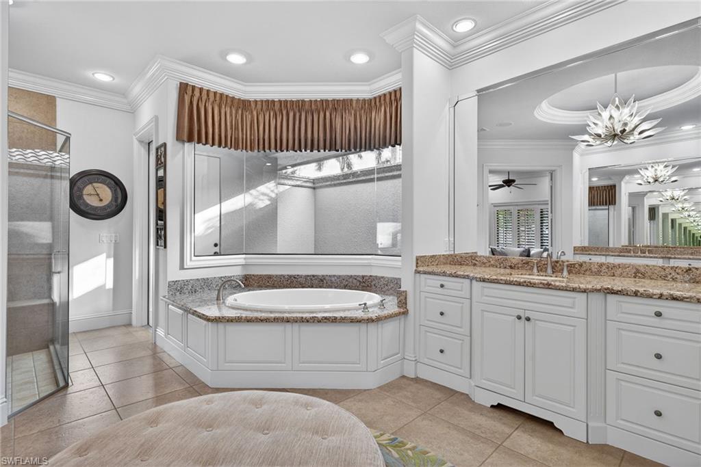 16488 Felicita Court Naples, FL 34110 - Photo 22 of 50 a bathroom with a granite countertop double vanity sink mirror bathtub and shower