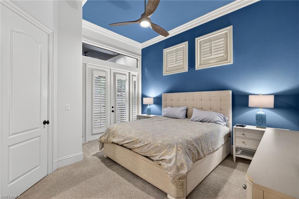 16488 Felicita Court Naples, FL 34110 - Photo 27 of 50 a bedroom with a bed and a lamp
