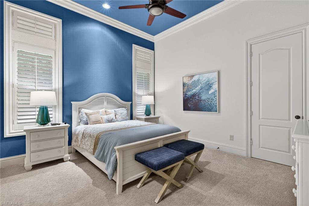 16488 Felicita Court Naples, FL 34110 - Photo 29 of 50 a bedroom with a bed and a chandelier