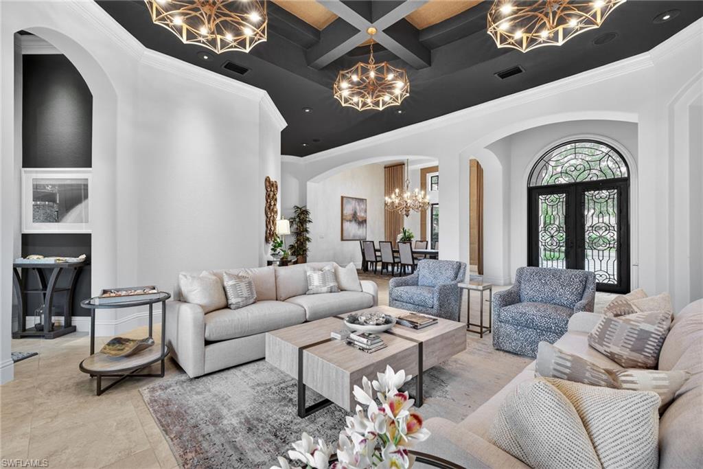 16488 Felicita Court Naples, FL 34110 - Photo 3 of 50 a living room with furniture a chandelier and a large window