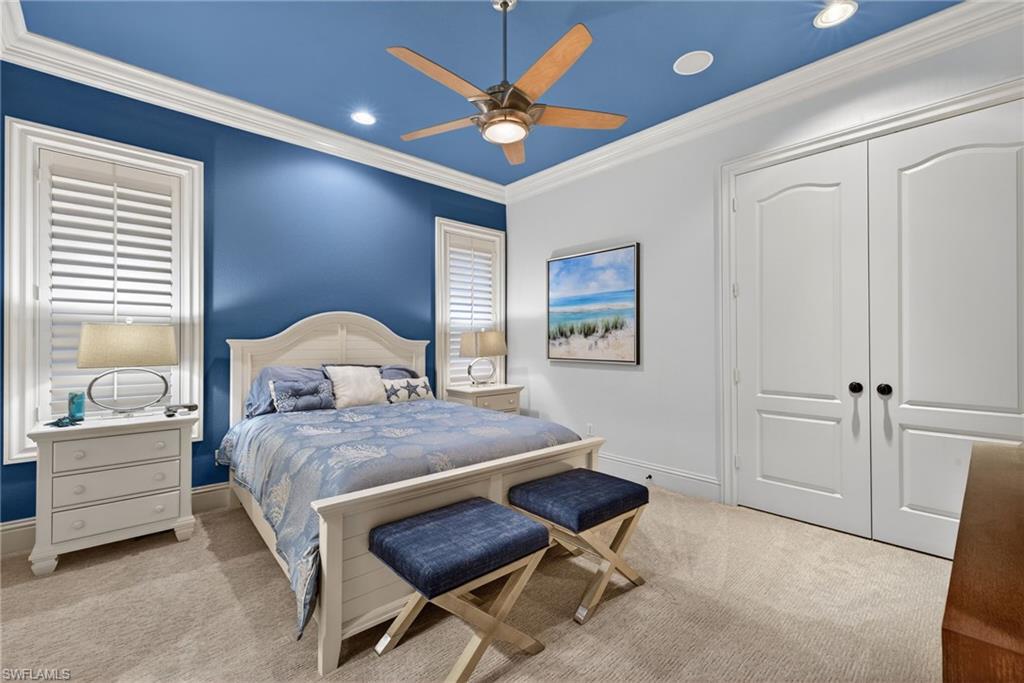 16488 Felicita Court Naples, FL 34110 - Photo 31 of 50 a bedroom with a bed a table and chair