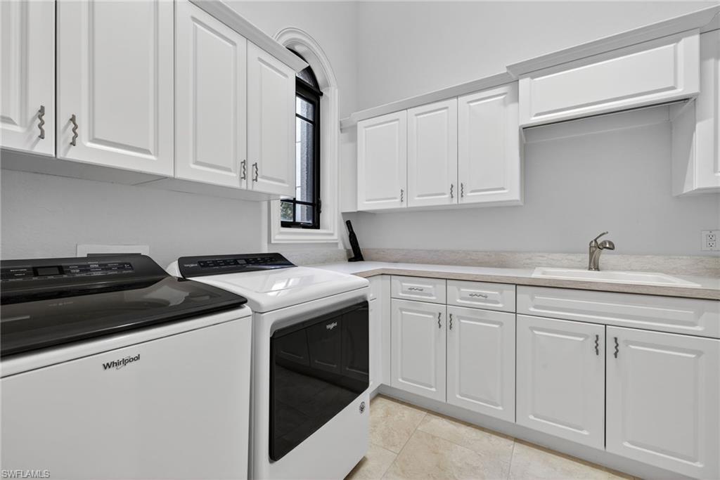 16488 Felicita Court Naples, FL 34110 - Photo 33 of 50 a kitchen with white cabinets and white appliances