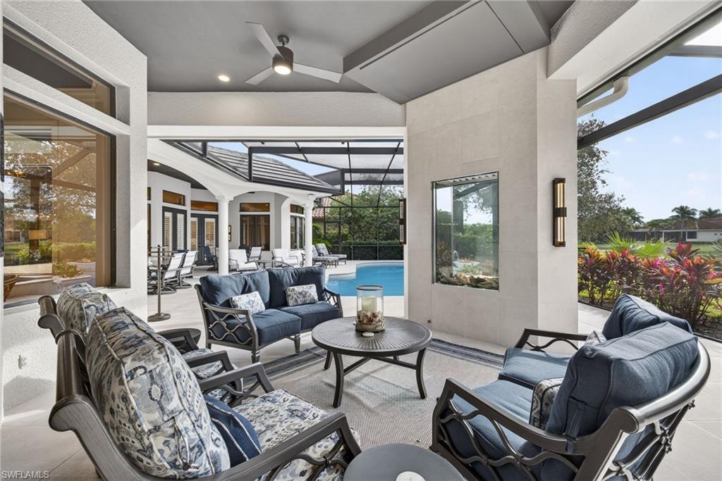 16488 Felicita Court Naples, FL 34110 - Photo 38 of 50 a living room with furniture and a floor to ceiling window