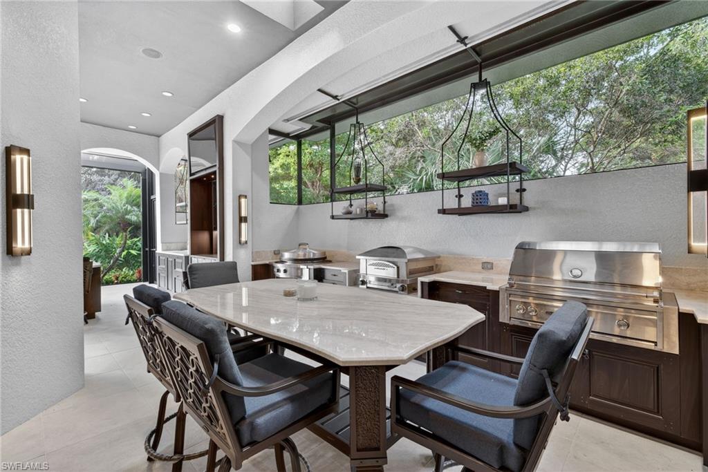 16488 Felicita Court Naples, FL 34110 - Photo 41 of 50 a view of a dining room with furniture window and outside view
