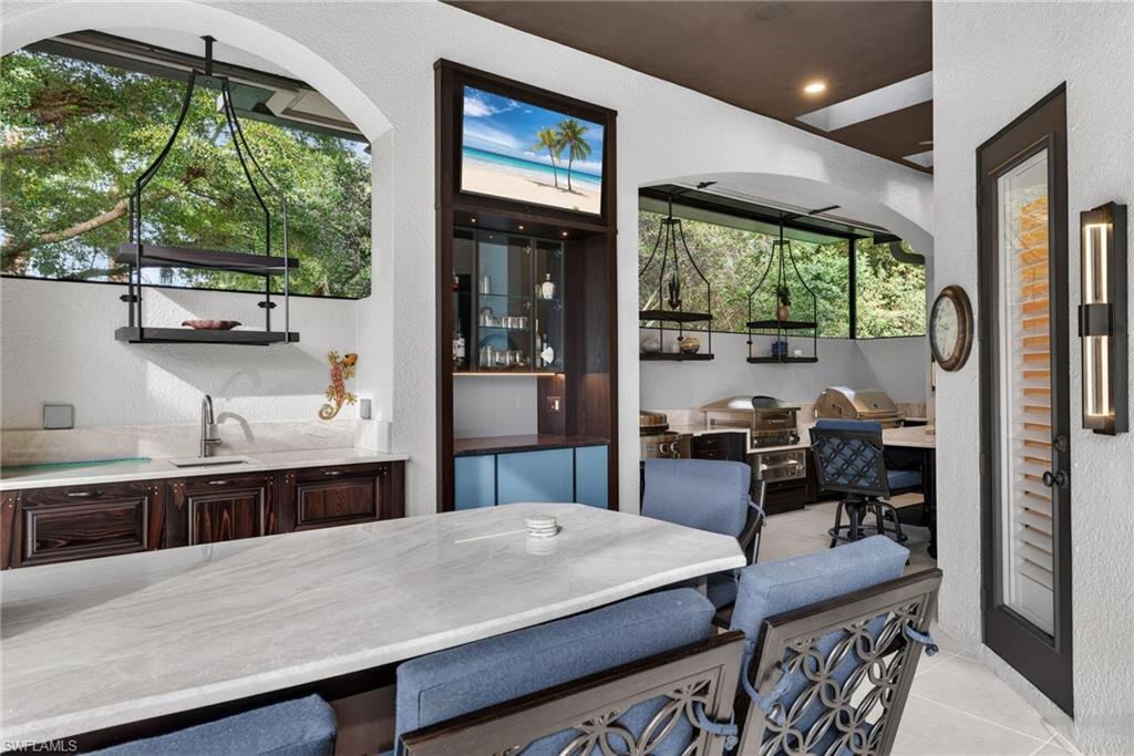 16488 Felicita Court Naples, FL 34110 - Photo 42 of 50 a dining room with a large window and table