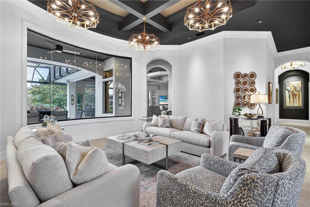 16488 Felicita Court Naples, FL 34110 - Photo 5 of 50 a living room with furniture a chandelier and a large window