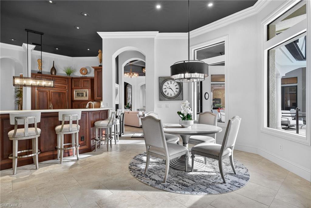 16488 Felicita Court Naples, FL 34110 - Photo 7 of 50 a view of a dining room with furniture