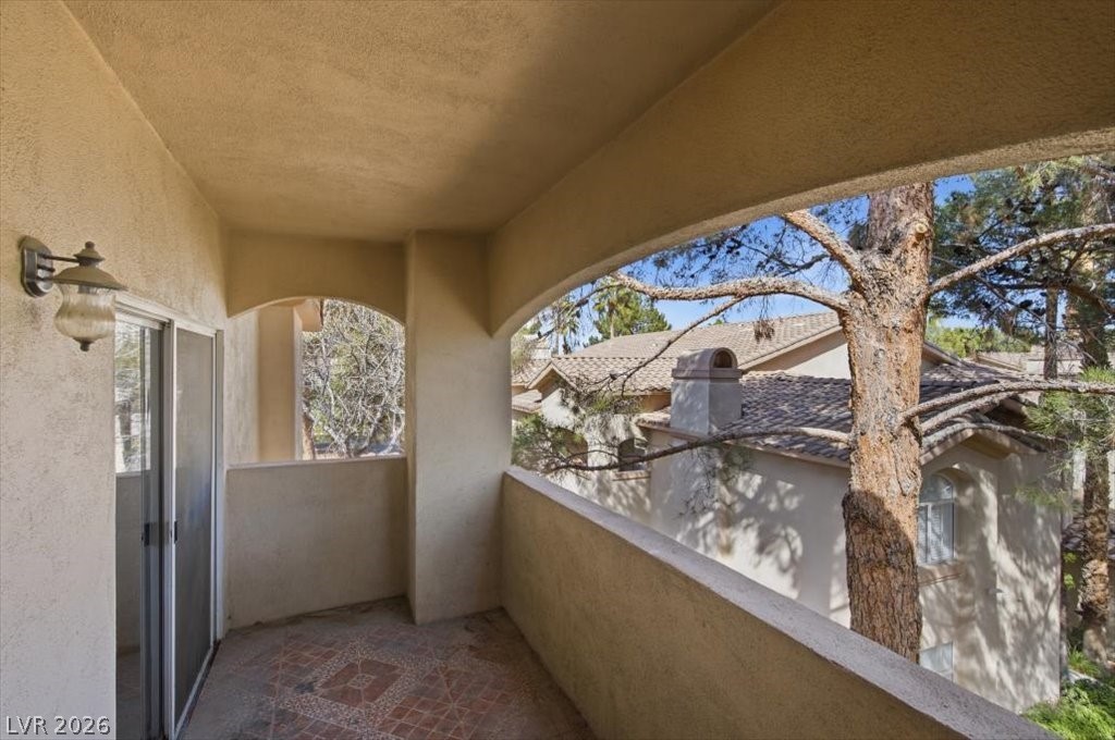 2050 West Warm Springs Road, Unit 3722 Henderson, NV 89014 - Photo 19 of 37 Spacious covered balcony with tile flooring and views of the lush mature landscaping