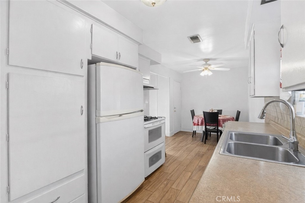 1650 Orange Street Riverside, CA 92501 - Photo 12 of 60 a kitchen with stainless steel appliances a refrigerator and a sink