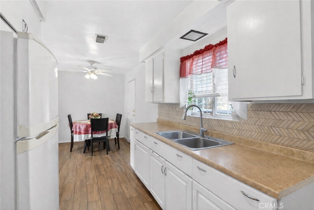 1650 Orange Street Riverside, CA 92501 - Photo 13 of 60 a kitchen with a sink cabinets and wooden floor
