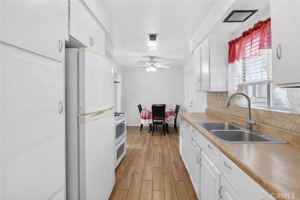 1650 Orange Street Riverside, CA 92501 - Photo 15 of 60 a kitchen with sink cabinets and wooden floor
