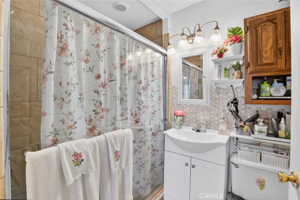 1650 Orange Street Riverside, CA 92501 - Photo 17 of 60 a bathroom with a sink and a mirror