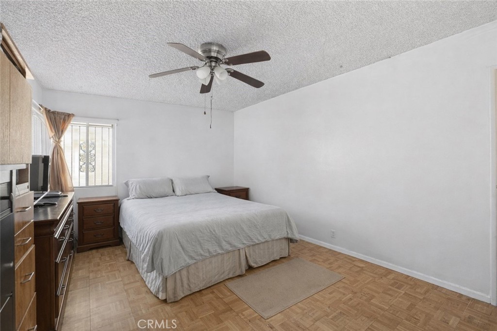 1650 Orange Street Riverside, CA 92501 - Photo 21 of 60 a bedroom with a bed and a chandelier