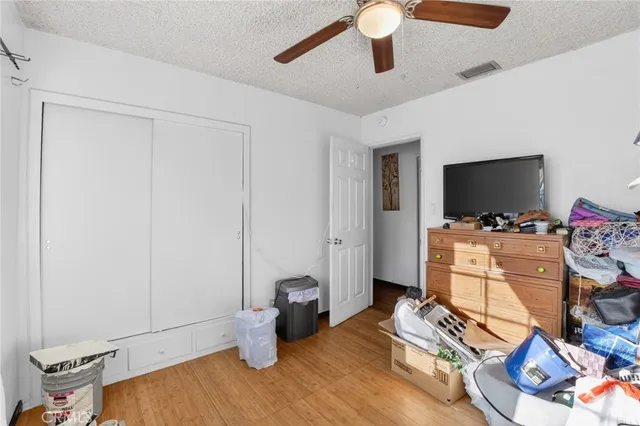 a bedroom with a bed a desk and chair