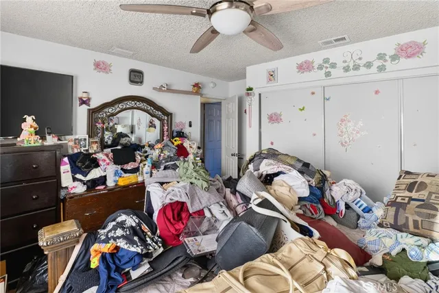a view of a house with a yard and table and chairs under an umbrella