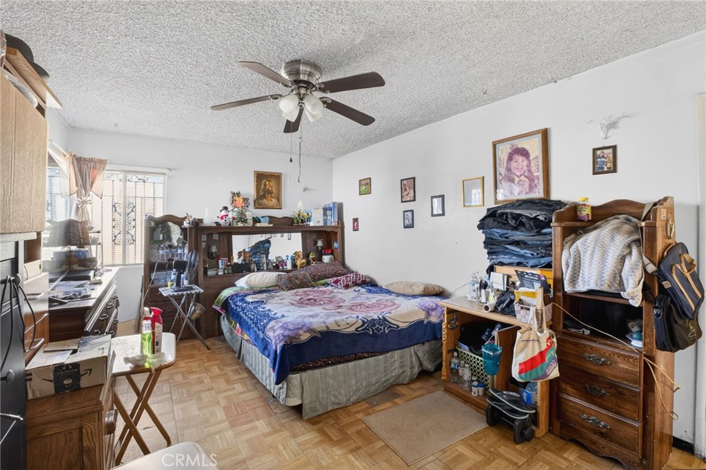 1650 Orange Street Riverside, CA 92501 - Photo 41 of 60 a bedroom with a bed a desk and chair