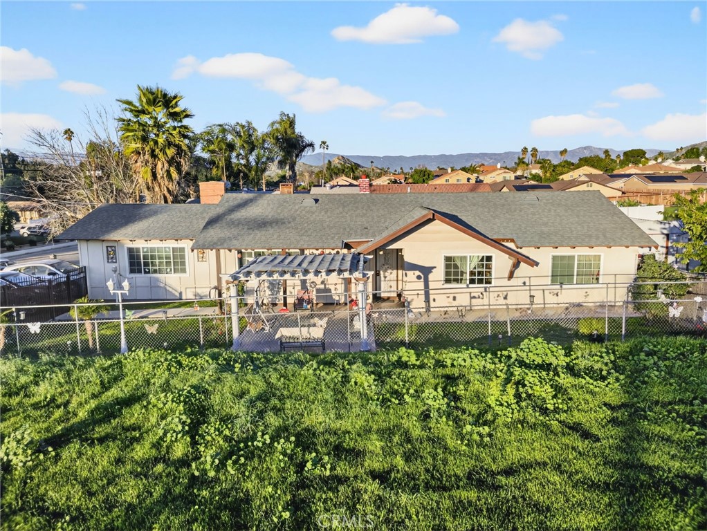1650 Orange Street Riverside, CA 92501 - Photo 43 of 60 a view of a house with a yard and table and chairs under an umbrella