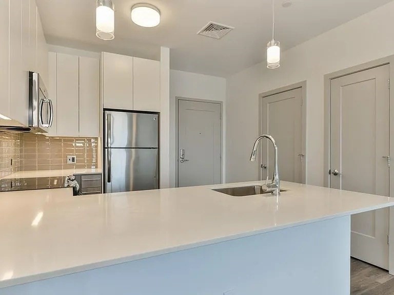 180 Telford Street, Unit 321 Boston, MA 02135 - Photo 4 of 10 a bathroom with a sink and a mirror