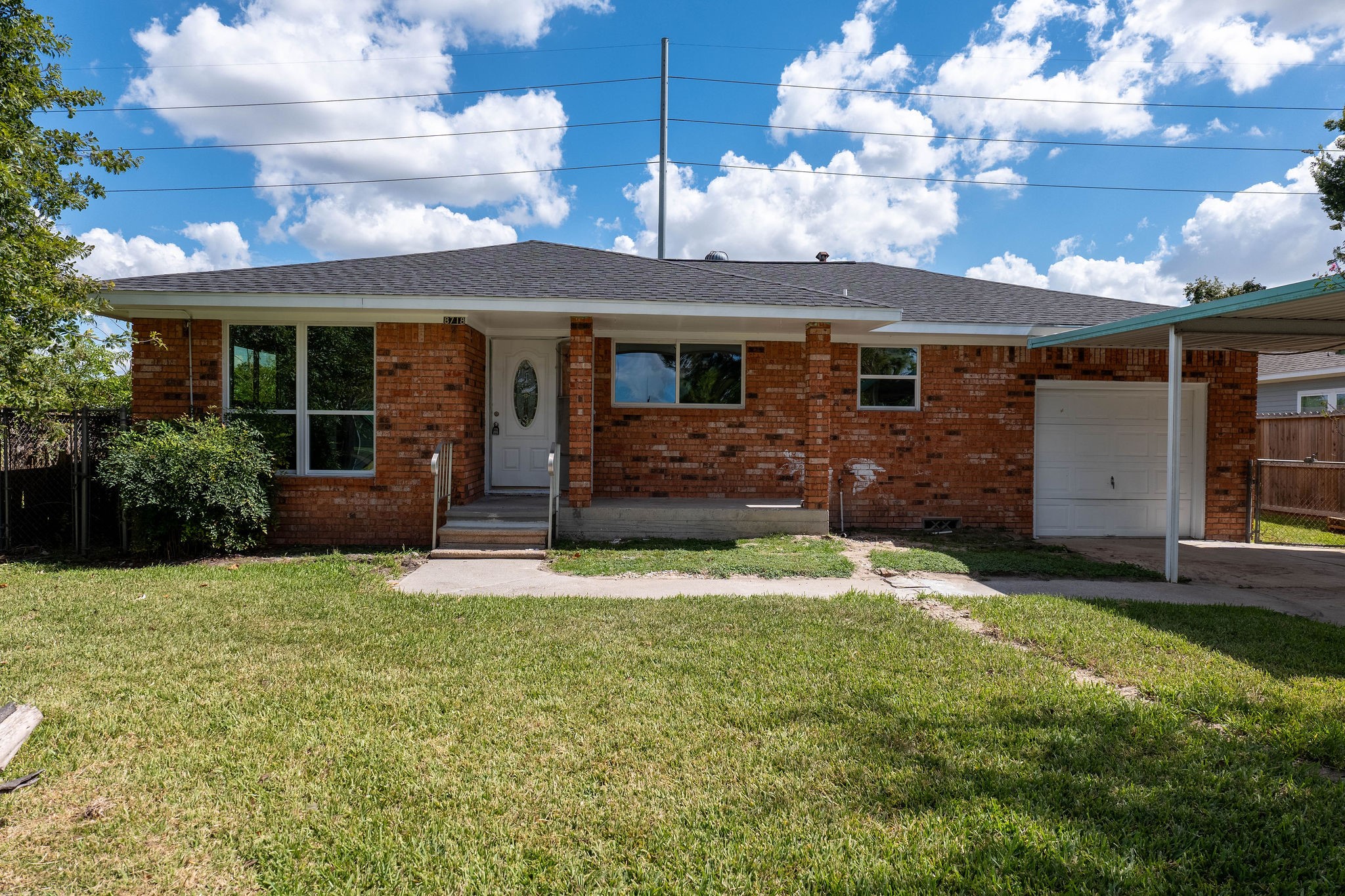 8718 Magna Street Houston, TX 77093 - Photo 1 of 33 a front view of a house with a yard and garage