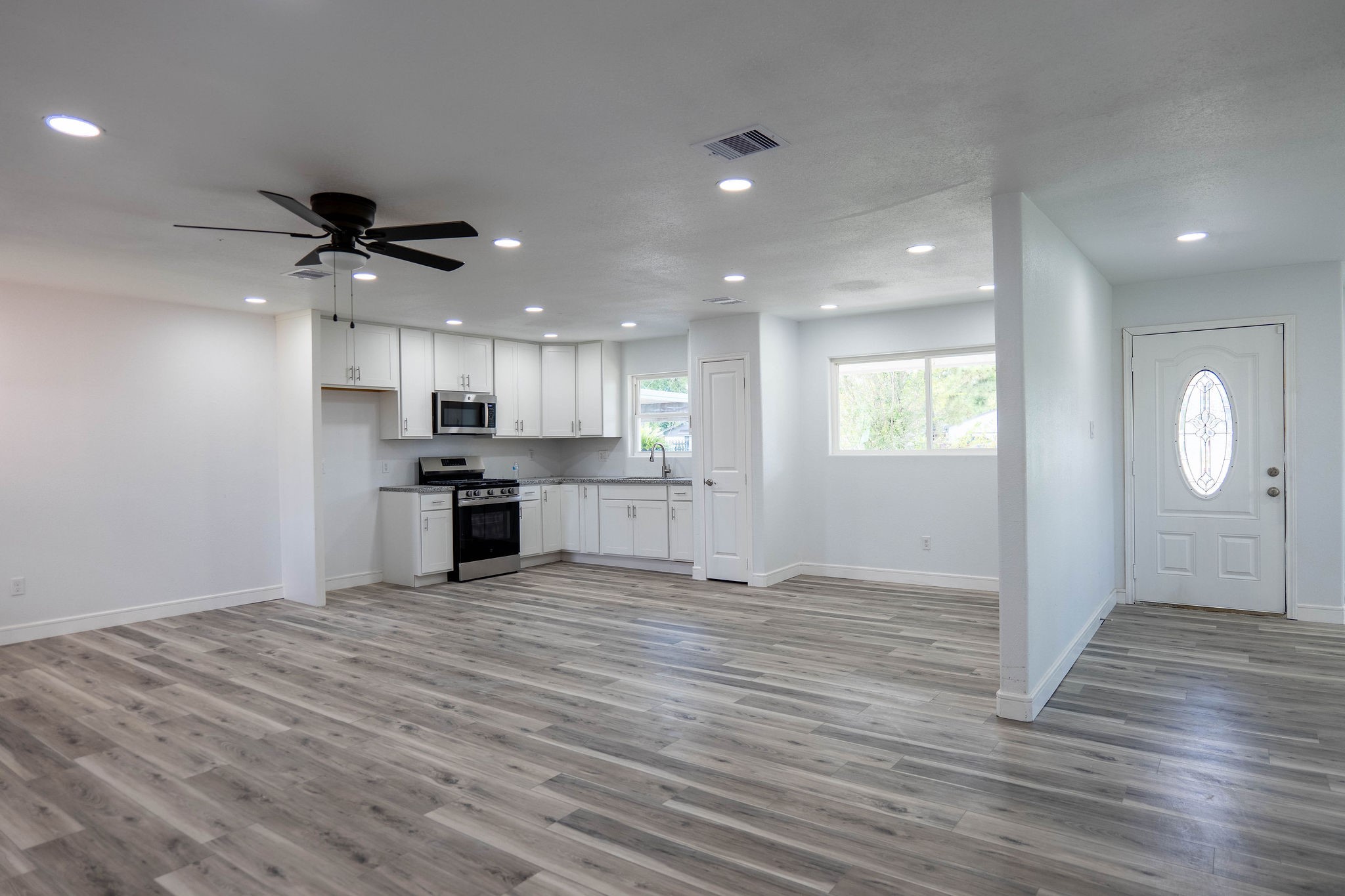 8718 Magna Street Houston, TX 77093 - Photo 12 of 33 a view of kitchen with granite countertop cabinets and wooden floor