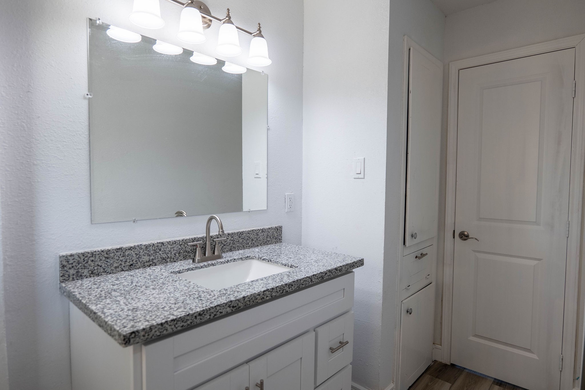 8718 Magna Street Houston, TX 77093 - Photo 15 of 33 a bathroom with a granite countertop sink and a mirror