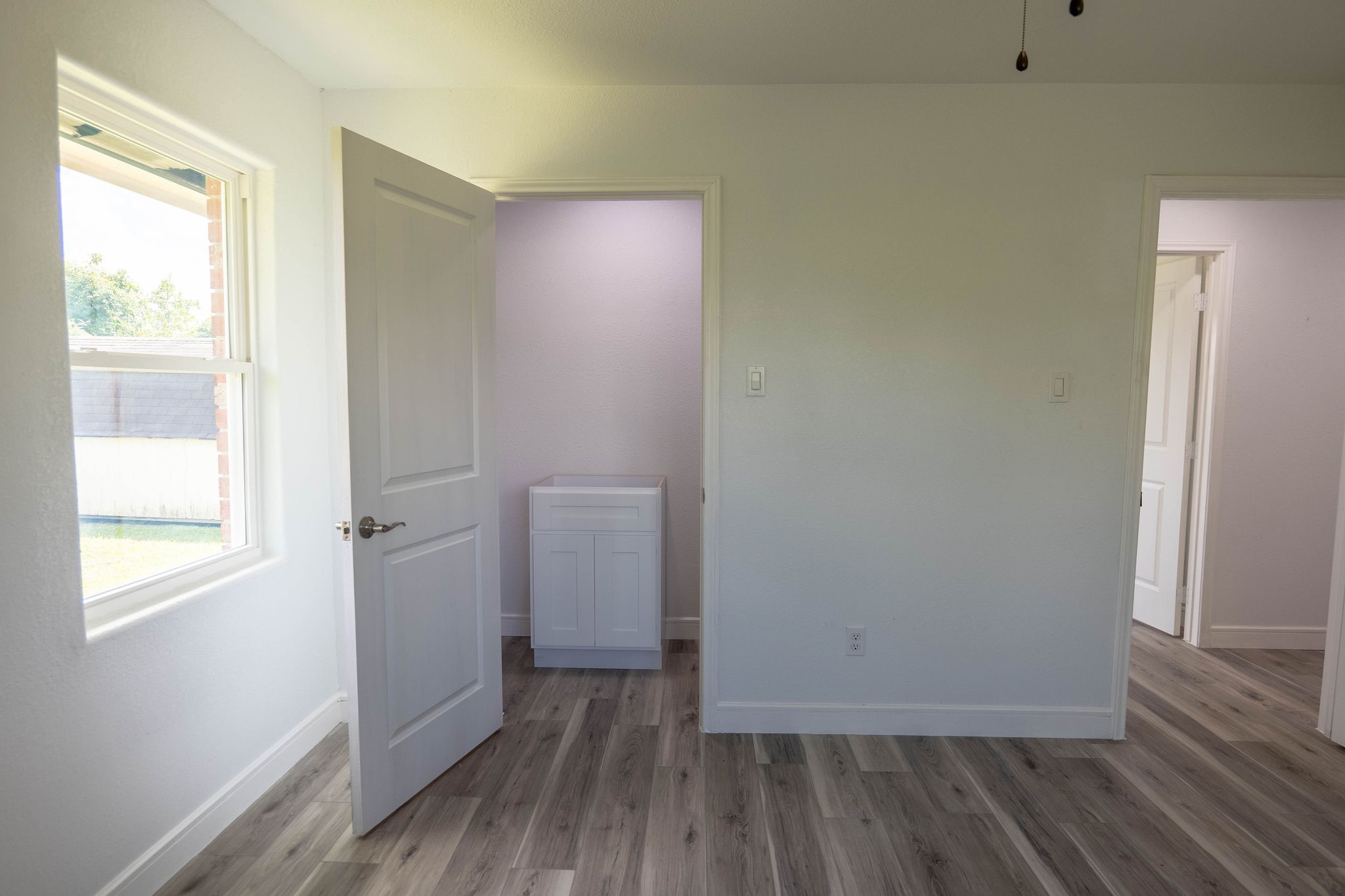 8718 Magna Street Houston, TX 77093 - Photo 19 of 33 a view of a room with wooden floor and windows