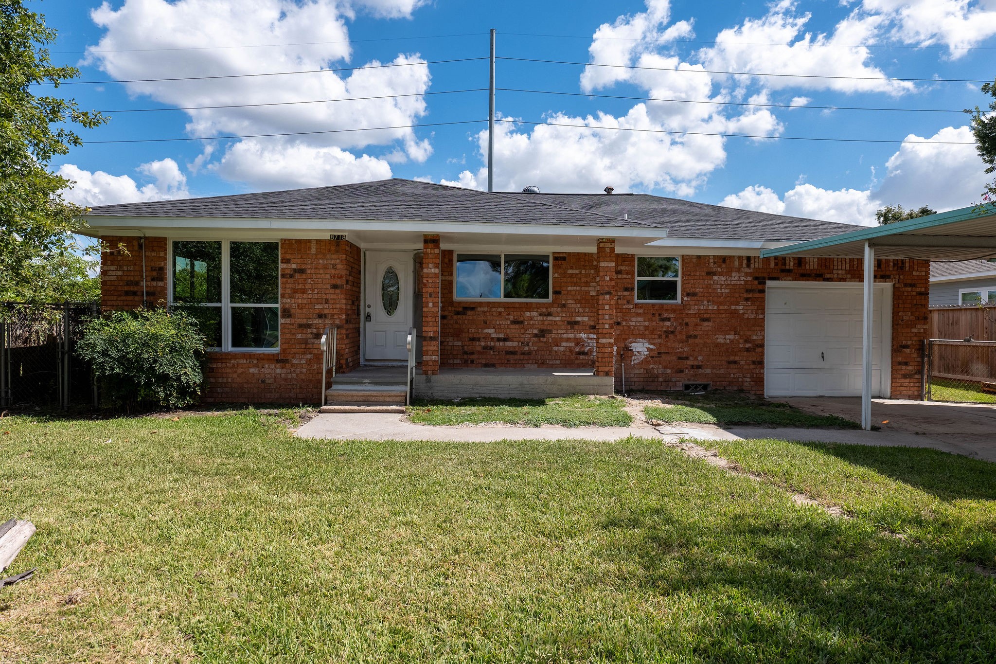 8718 Magna Street Houston, TX 77093 - Photo 2 of 33 a front view of a house with a yard and garage