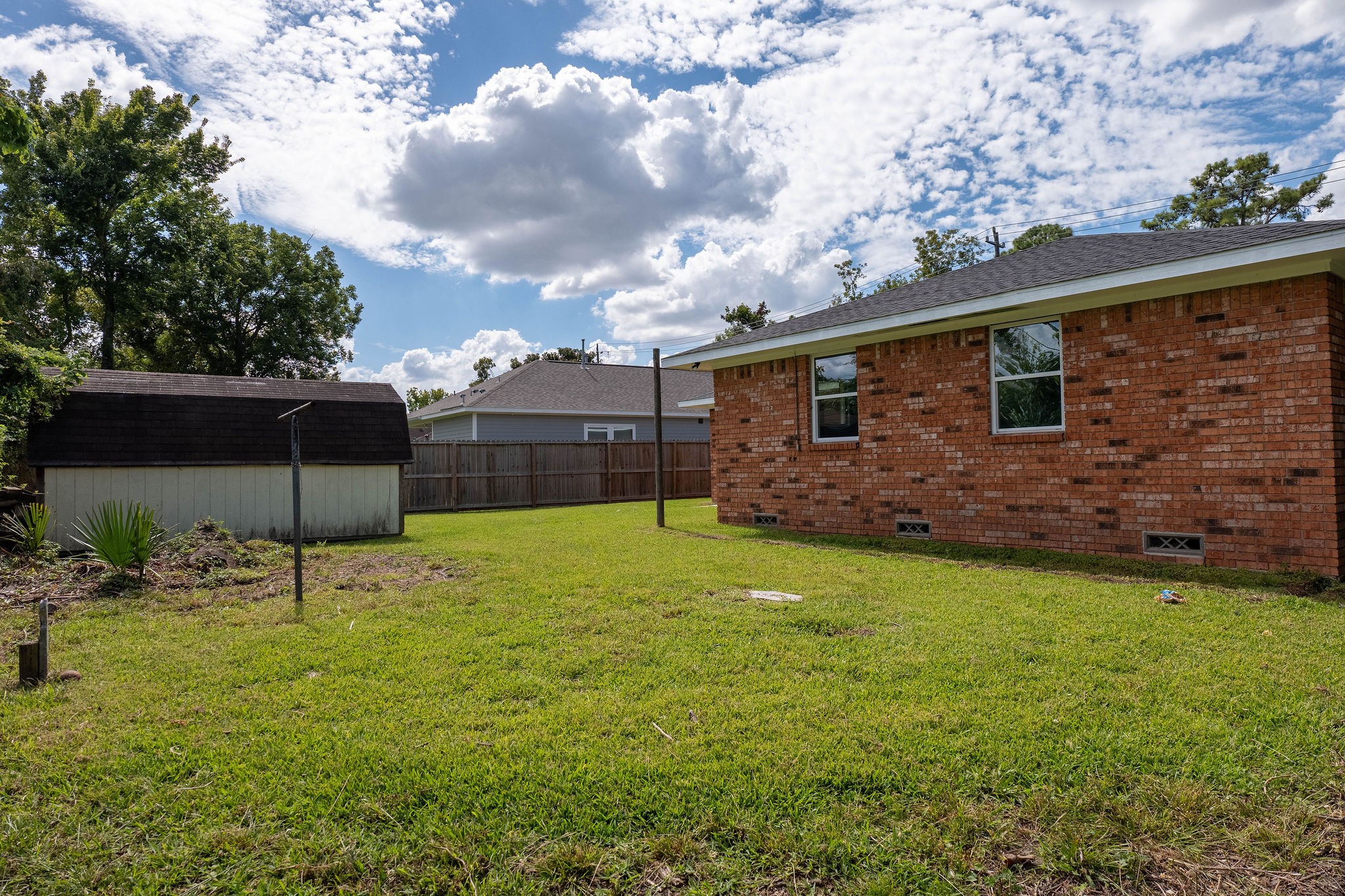 8718 Magna Street Houston, TX 77093 - Photo 28 of 33 a backyard of a house with lots of green space