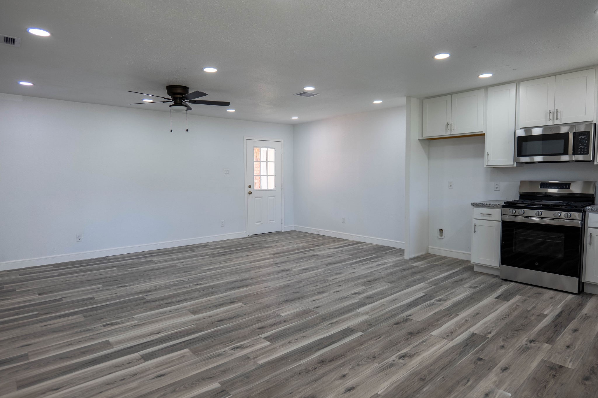 8718 Magna Street Houston, TX 77093 - Photo 6 of 33 a view of a kitchen with a stove cabinets and wooden floor